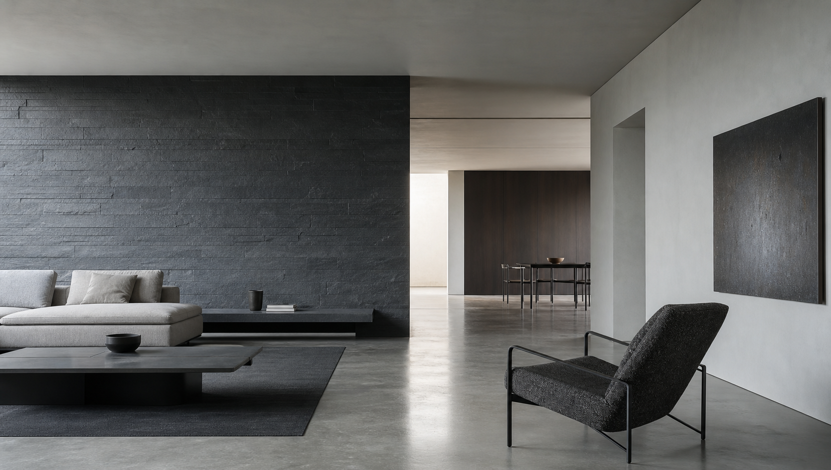 Interno minimale in cemento e pietra con arredi essenziali